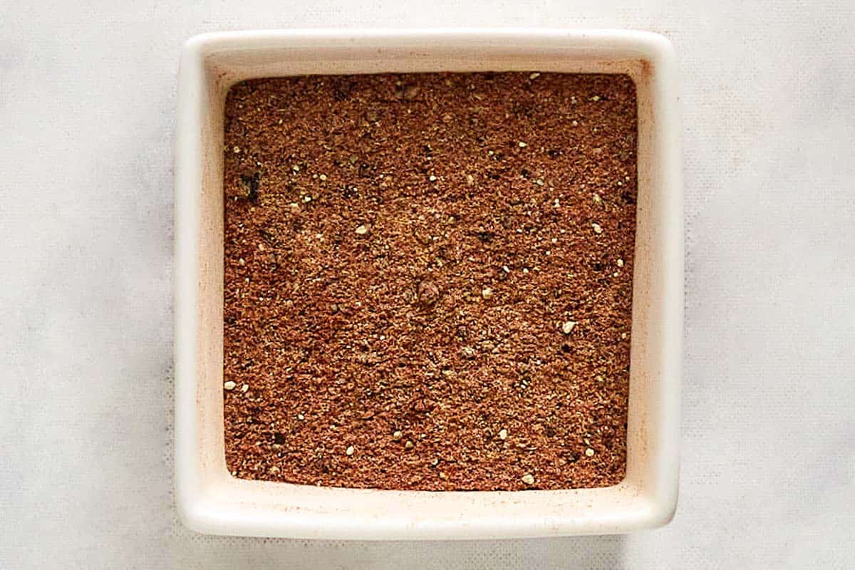 Homemade burger seasoning for grilling in a small square bowl.