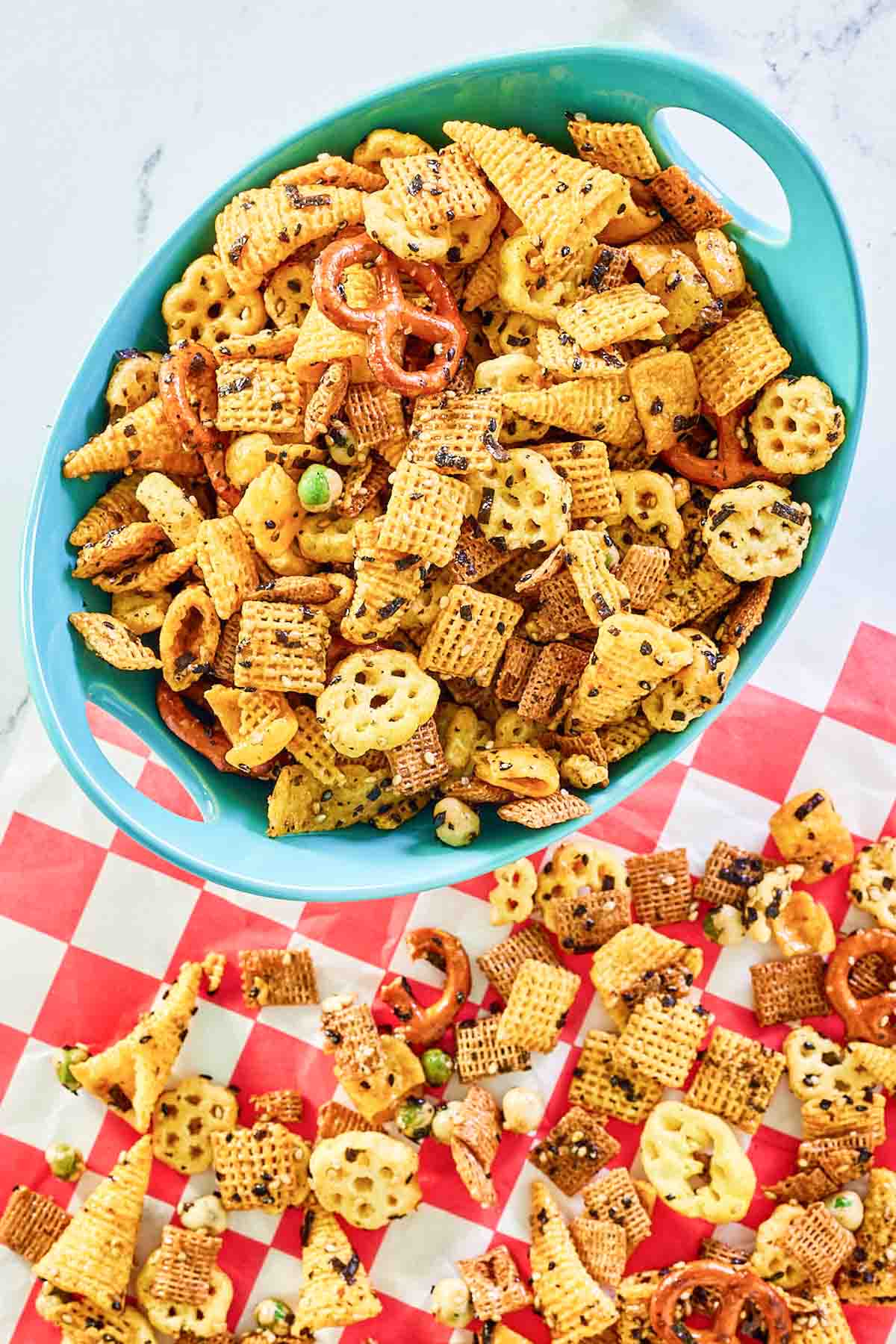 Furikake Chex Mix in a bowl and parchment paper.