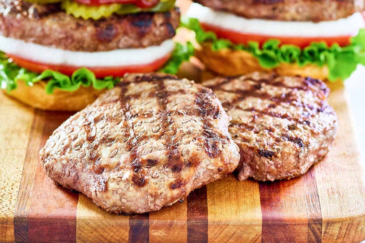 Grilled frozen burger patties and burgers made with them.