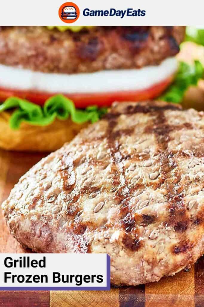 Grilled frozen burger patty on a wood board.