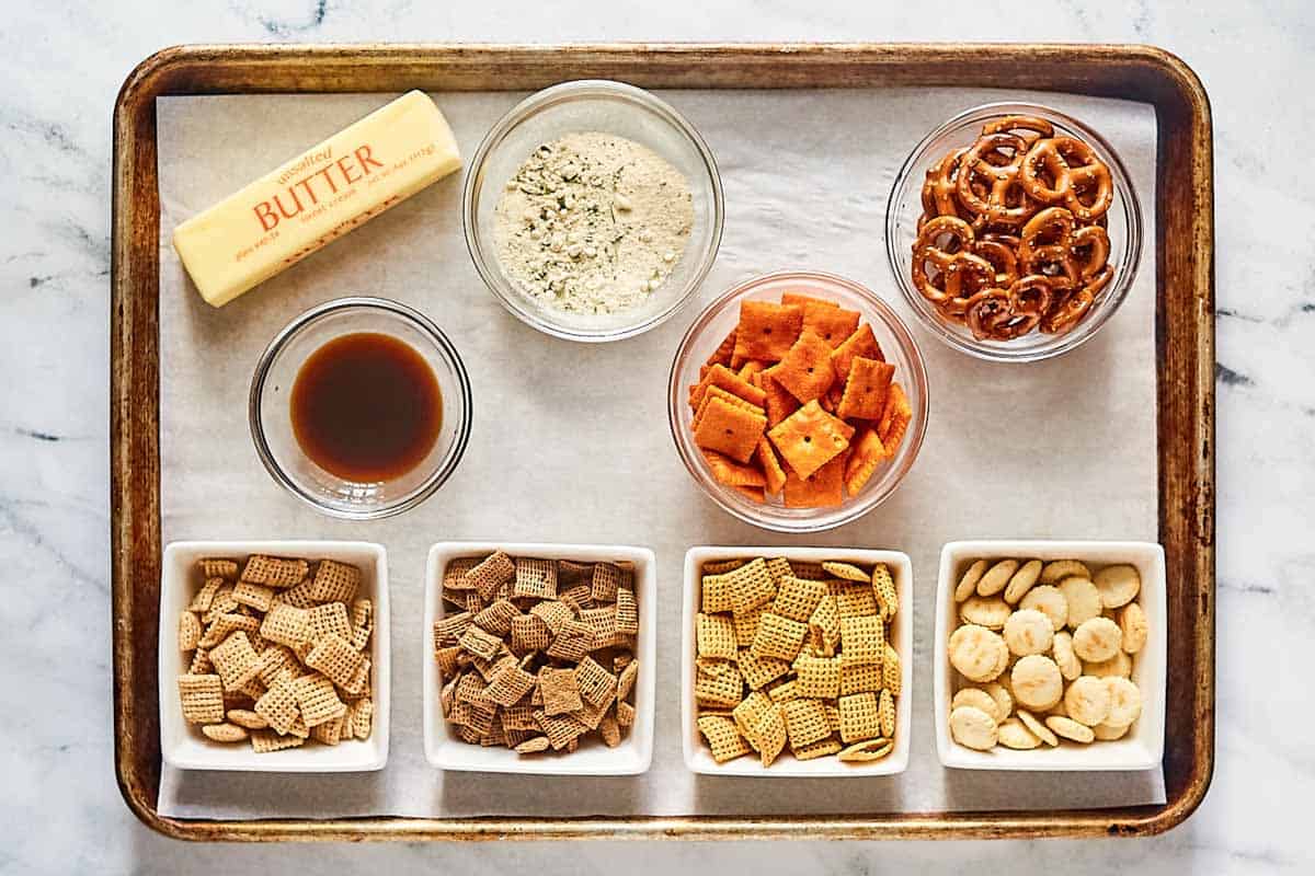 Cheesy ranch chex mix ingredients on a tray.