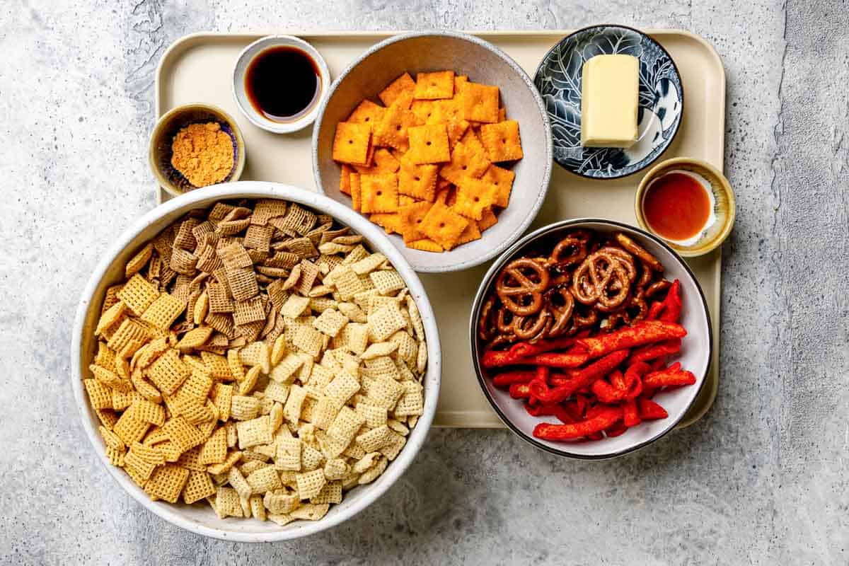 Homemade spicy Chex mix ingredients on a tray.