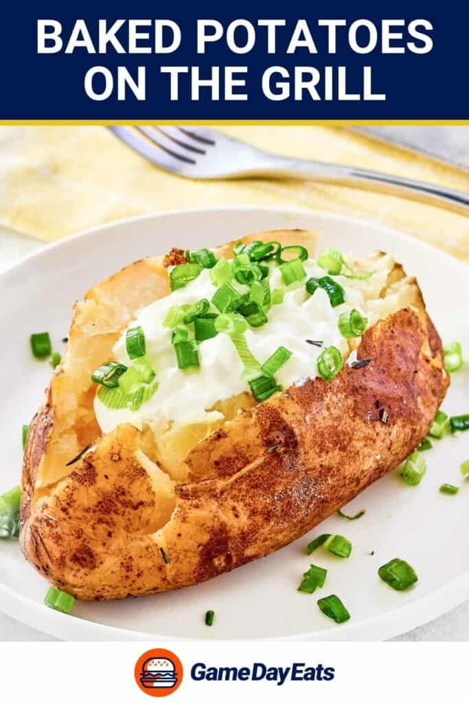 Grilled baked potato on a plate and a fork behind it.