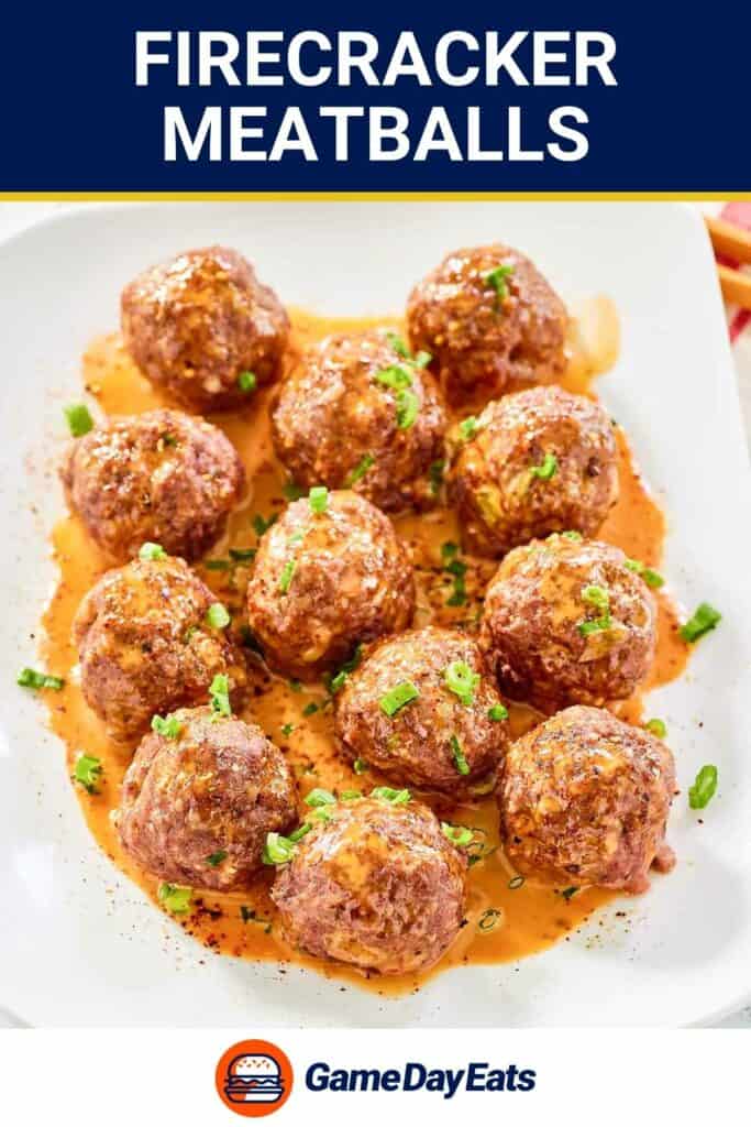 Firecracker meatballs garnished with green onions on a large plate.