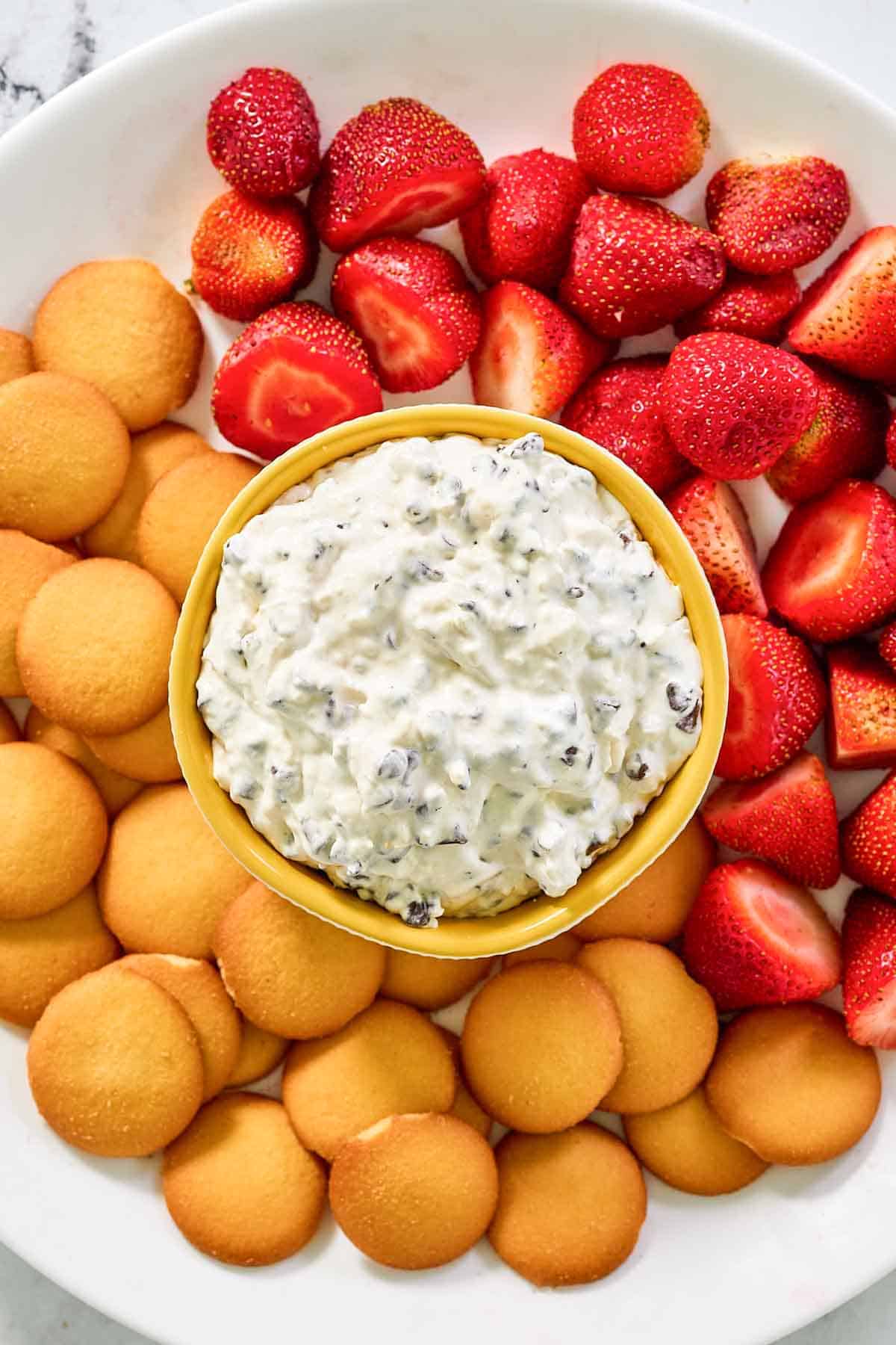 Booty dip, vanilla wafers, and strawberries on a platter.