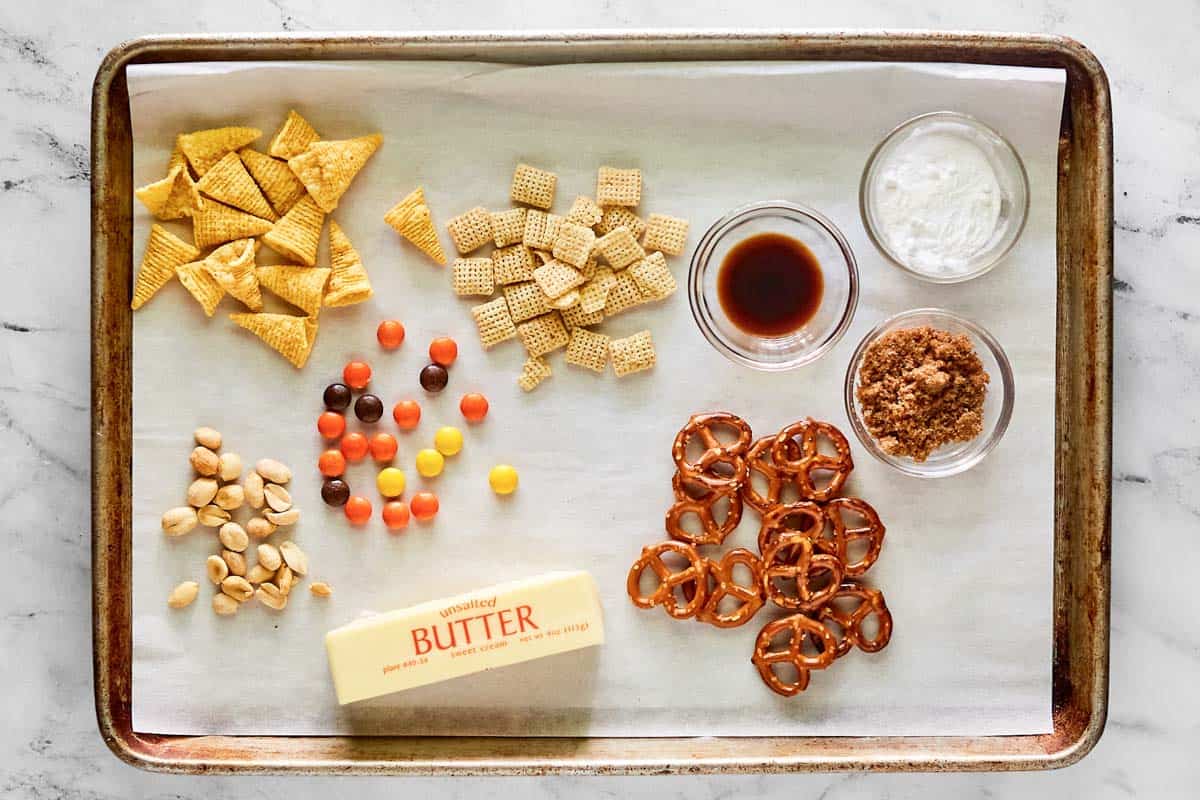 Sweet and salty chex mix ingredients on a tray.