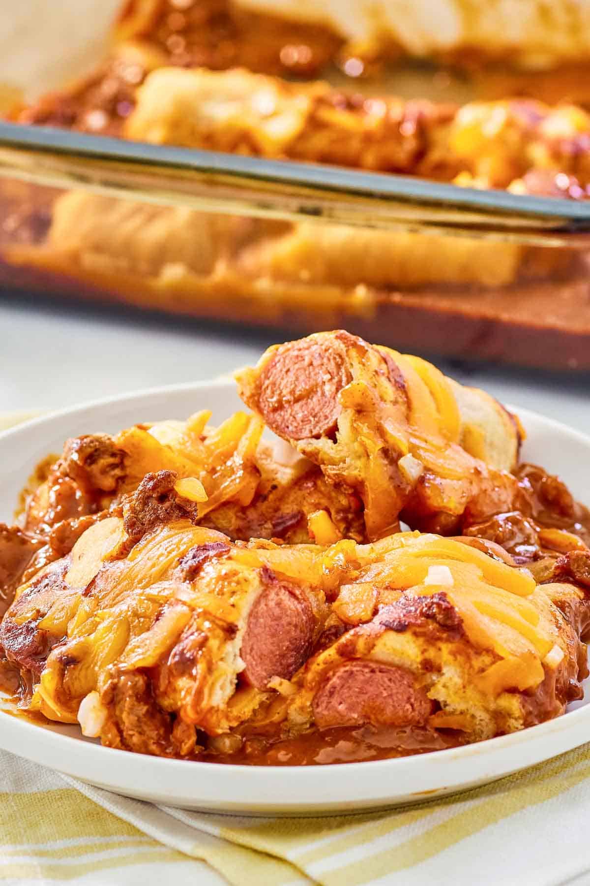 Chili dog casserole on a plate and in a baking dish.